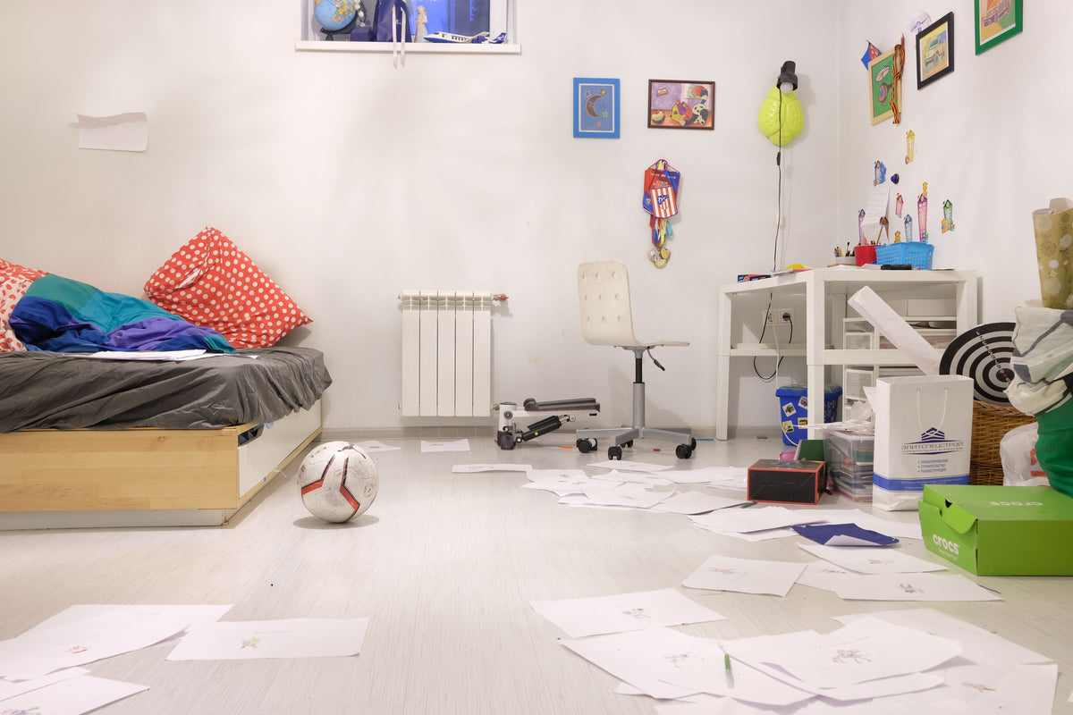 Messy children's bedroom with toys and papers ready to be tidied