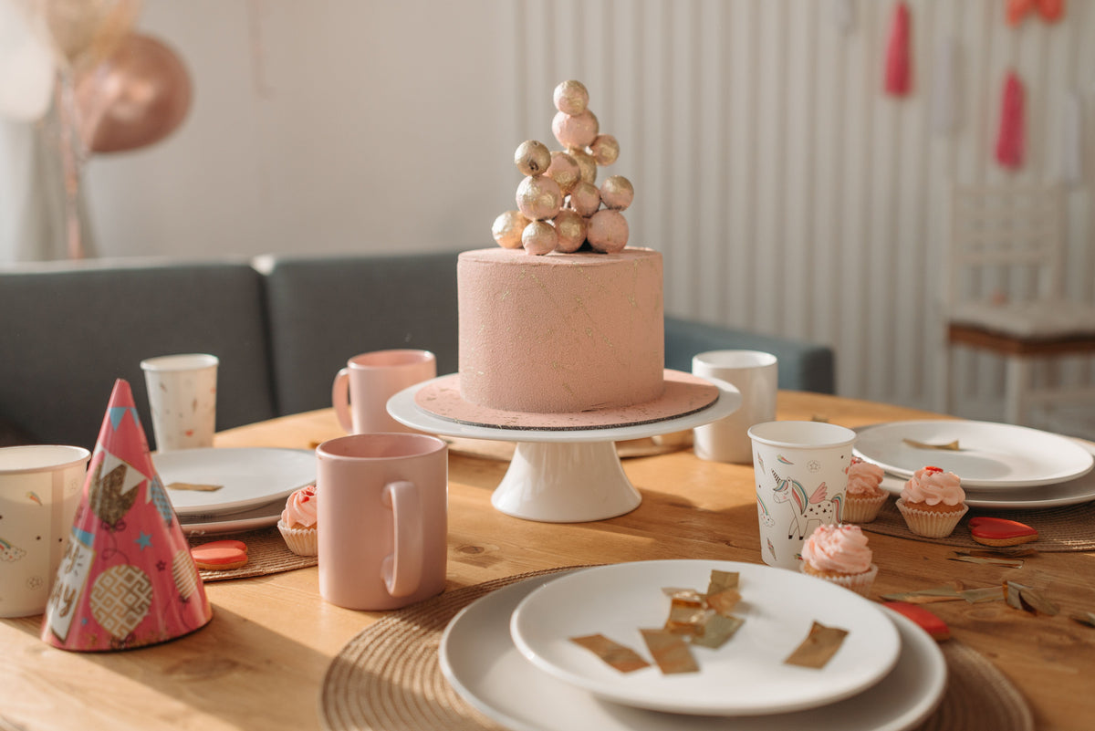 Birthday party table prepared with cake and simple decorations