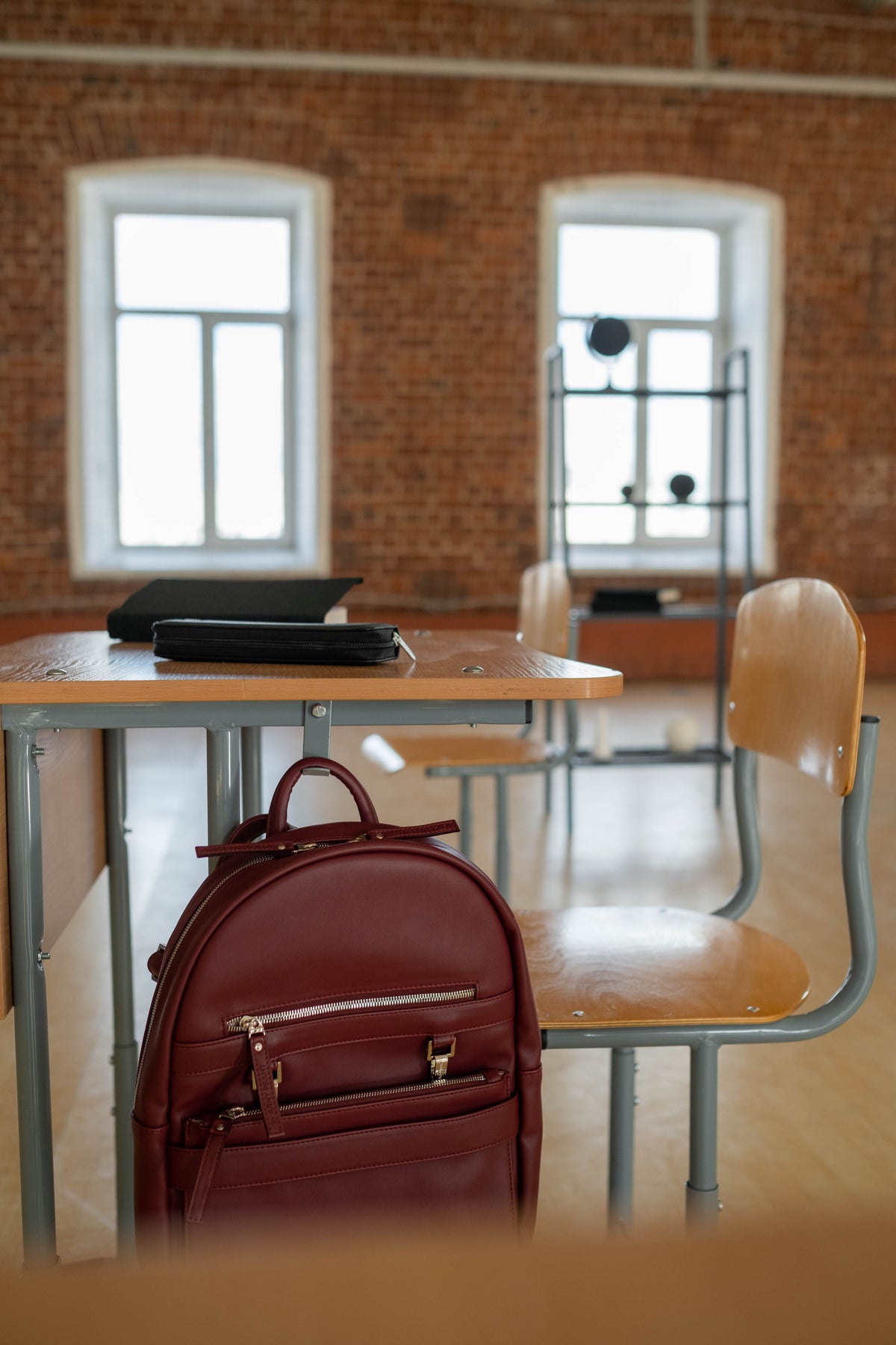 School backpack ready beside a classroom desk