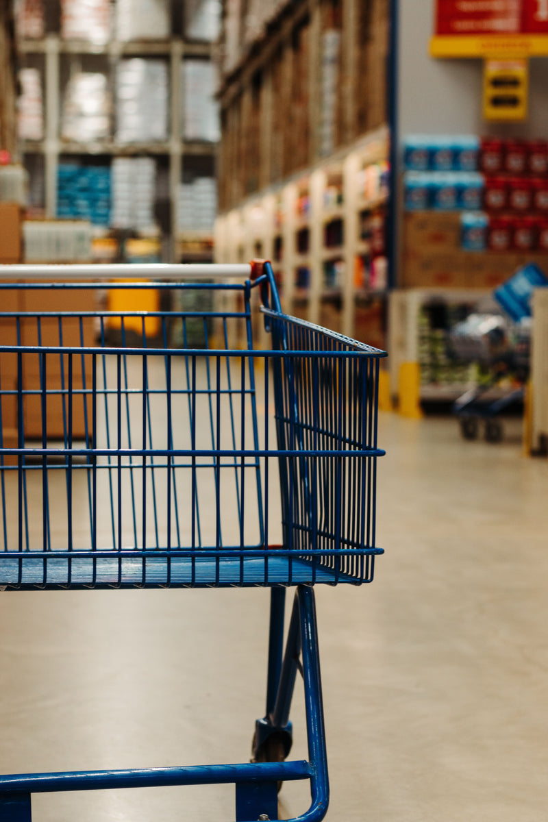 Empty shopping trolley in a supermarket aisle