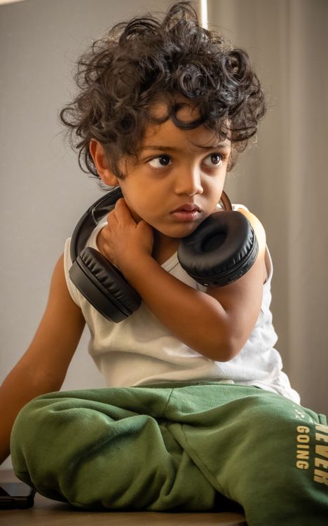 Child wearing headphones to reduce sensory input