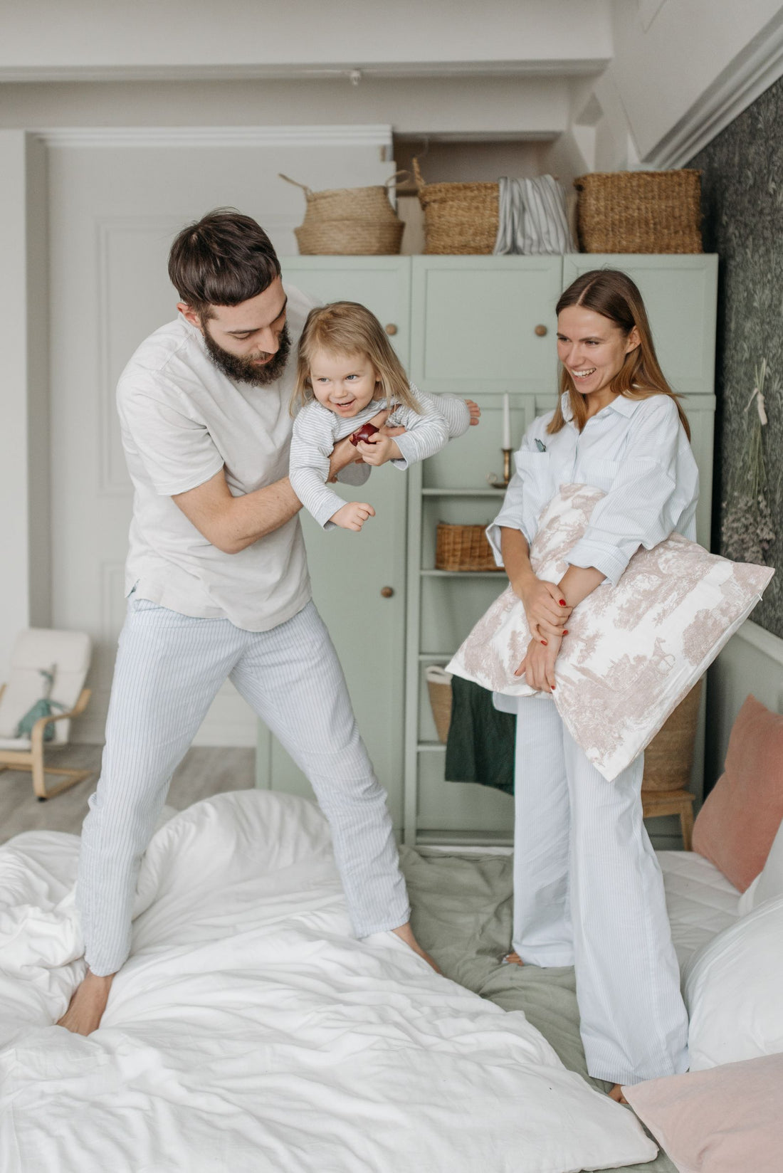 Family sharing a relaxed morning routine in a bedroom