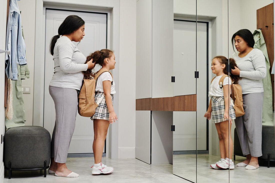 Parent and child getting ready together in front of a mirror