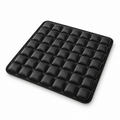 Black inflatable seat cushion with raised air cells on a white background