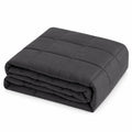 Grey weighted blanket for adults, folded to show the square quilting, on a white background
